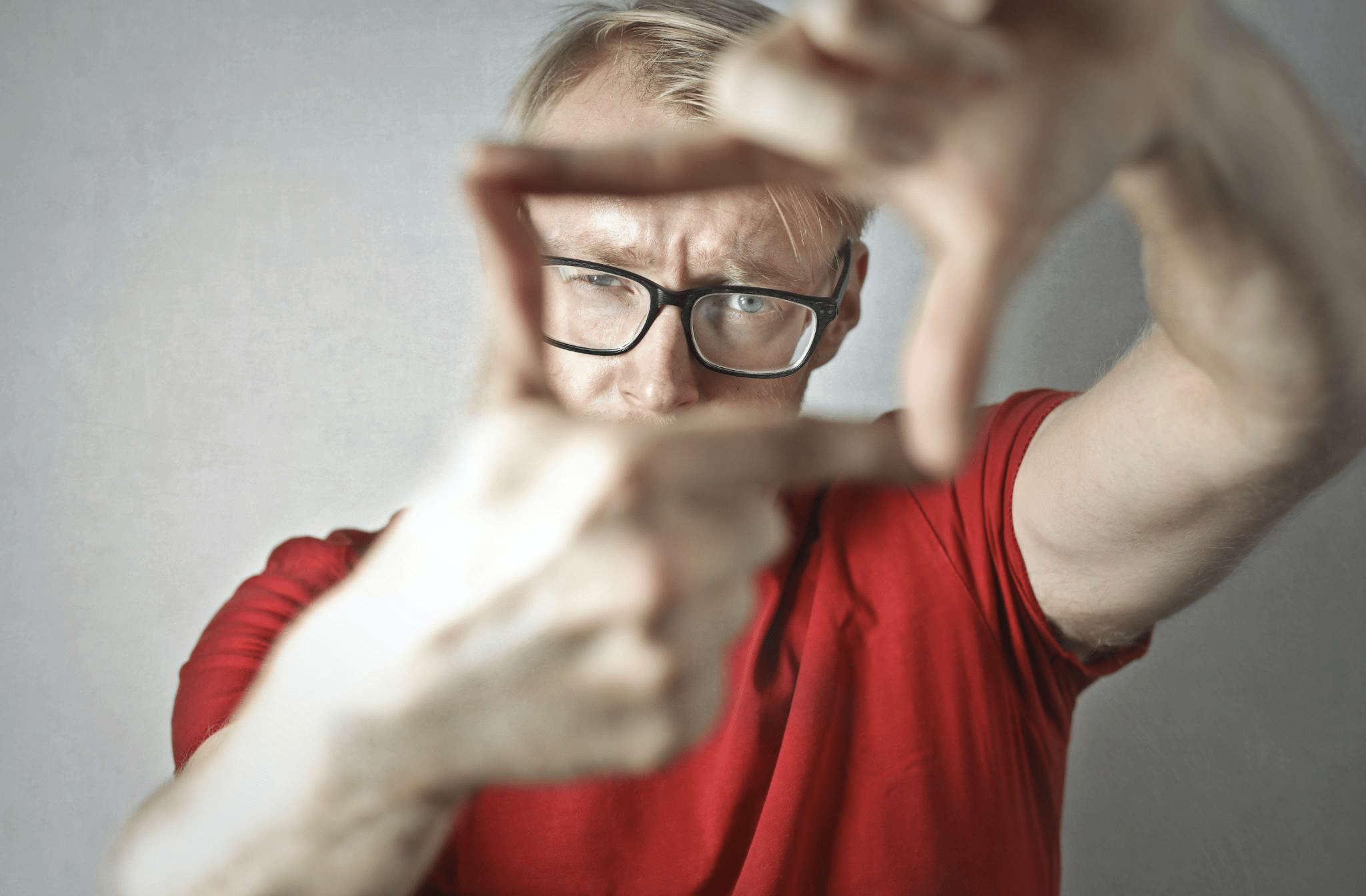 Artist focusing on a scene through an improvised frame